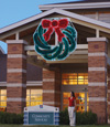 Daytime image of large garland wreath with bow