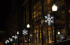 snowflake decorations lining street lamps